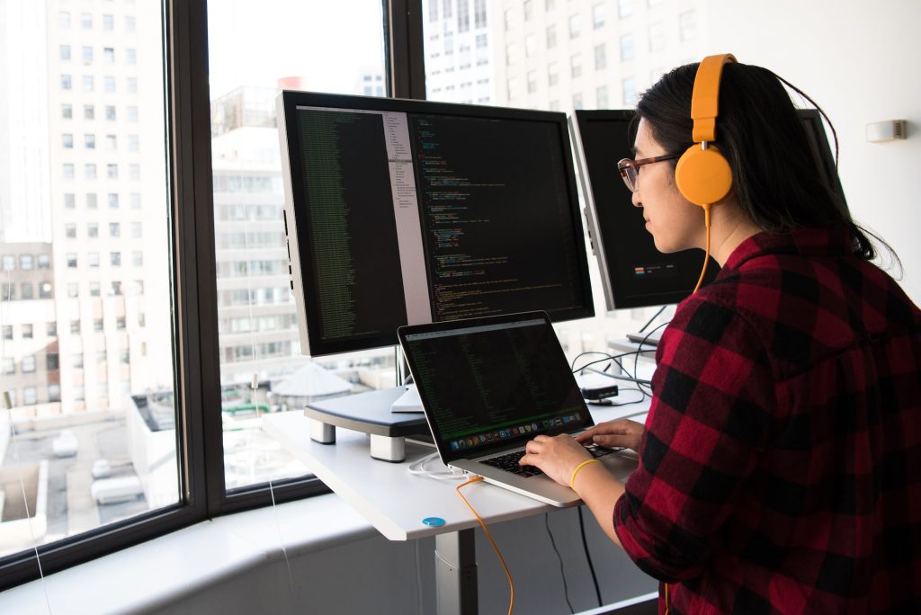 Woman software developer coding on computer